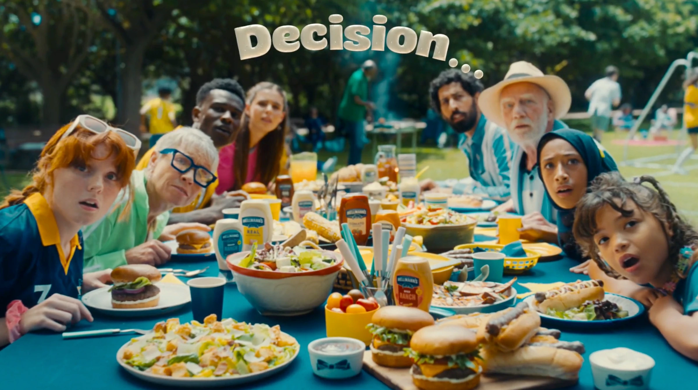 Guests gathered around a table of Hellmann’s sauces and BBQ food