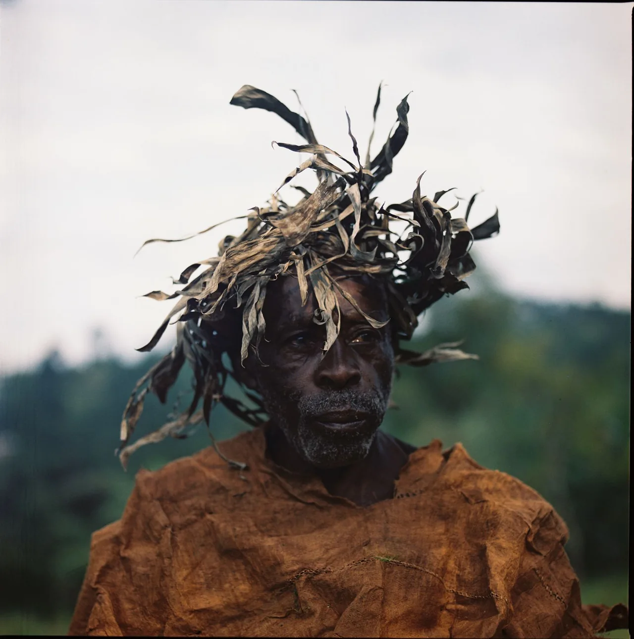 A man wearing a headdress made of leaves.