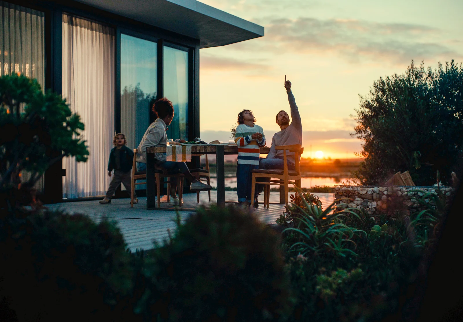 A family outside their Citra home at sunset.